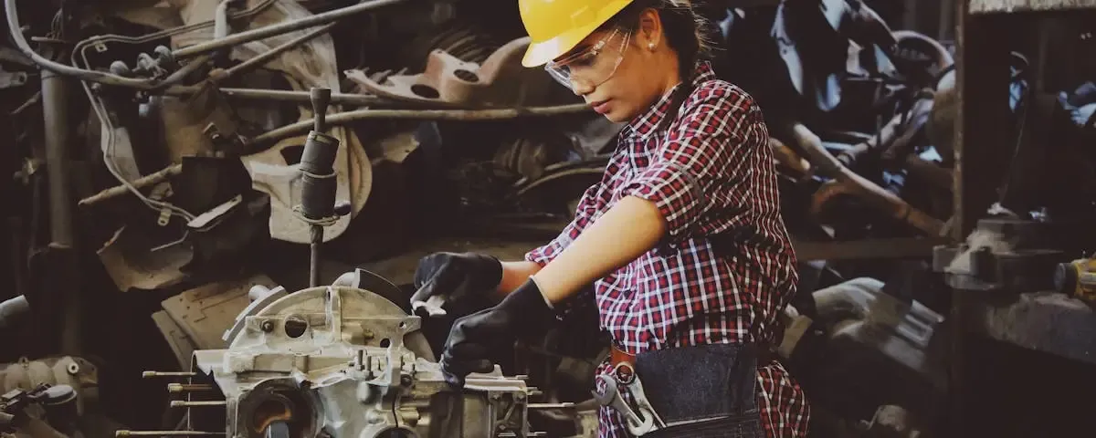 Industrial workshop technician working on machinery for Associated Gaskets